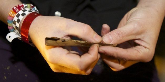SEATTLE, WASHINGTON - DECEMBER 6: A Tacoma resident rolls a joint shortly after a law legalizing the recreational use of marijuana took effect on December 6, 2012 in Seattle, Washington. Voters approved an initiative to decriminalize the recreational use of marijuana making it one of the first states to do so. (Photo by Stephen Brashear/Getty Images)