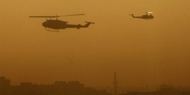 Military helicopters fly over the Green Zone area in Baghdad following a loud explosion early on October 18, 2010. Violence in Iraq has plunged dramatically since its peak in 2006-2007 but casualties from insurgent and military action still remain part of daily life. AFP PHOTO / SABAH ARAR (Photo credit should read SABAH ARAR/AFP/Getty Images)