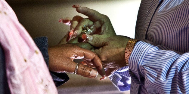 NEWARK, NJ - OCTOBER 21: Grace E. Guerrero (L) and Jeanette L. Williams exchange rings after being married by U.S. Senator-elect Cory Booker at City Hall in the early morning hours of October 21, 2013 in Newark, New Jersey. Same-sex couples were allowed to legally wed at 12:01 am on Monday across New Jersey, making the state the 14th to allow same-sex marriages. Following Friday's ruling by the New Jersey Supreme Court, Mayor Cory A. Booker will marry seven gay, lesbian, and straight couples at City Hall in Newark on Monday morning. (Photo by Kena Betancur/Getty Images)