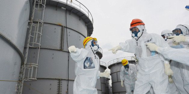 Fukushima Governor Yuhei sato (orange helmet) inspects the contaminated water tanks at Tokyo Electric Power Co (TEPCO) Fukushima Dai-ichi nuclear power plant at Okuma town in Fukushima prefecture on October 15, 2013. Radioactive water leaked from the tanks early this month and flowed into the Pacific Ocean. AFP PHOTO / JAPAN POOL via JIJI PRESS JAPAN OUT (Photo credit should read JAPAN POOL/AFP/Getty Images)