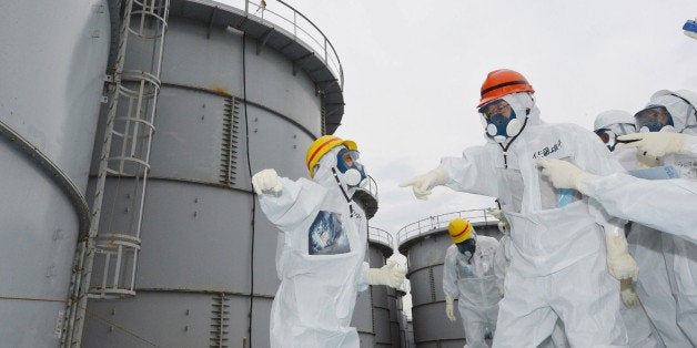 Fukushima Governor Yuhei sato (orange helmet) inspects the contaminated water tanks at Tokyo Electric Power Co (TEPCO) Fukush