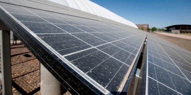 Solar panels stand next to the Arizona State University Verde Dickey Dome in Tempe, Arizona, U.S., on Tuesday, June 11, 2013. Solar installations in the first quarter increased 33 percent to account for almost half of all new electric capacity installed in the U.S., according to a trade-group report. Photographer: Laura Segall/Bloomberg via Getty Images