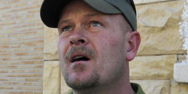 Samuel Joseph Wurzelbacher, or 'Joe the Plumber', looks at a building hit by a rocket launched by Gaza Strip militants in the