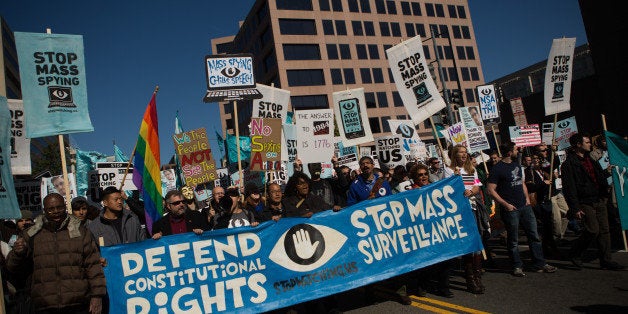 WASHINGTON, DC - OCTOBER 26, 2013: Protesters march through downtown Washington D.C. during the Stop Watching Us Rally protesting surveillance by the U.S. National Security Agency, on October 26, 2013, in front of the U.S. Capitol building in Washington, D.C. The rally began at Union Station and included a march that ended in front of the U.S. Capitol building and speakers such as author Naomi Wolf and former senior National Security Agency senior executive Thomas Drake. (Photo by Allison Shelley/Getty Images)