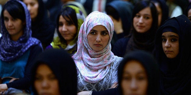 Afghan women listen to a speaker address a political gathering at a wedding hall in Kabul on September 26, 2013. Member of parliament Fawzia Kofi addressed approximately a hundred supporters in the hall ahead of the 2014 elections. AFP PHOTO/ SHAH Marai (Photo credit should read SHAH MARAI/AFP/Getty Images)