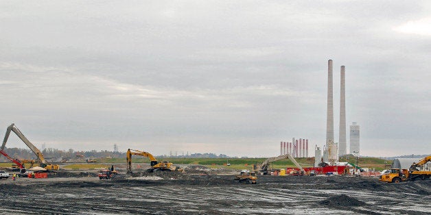 Machines work near the Tennessee Valley Authority Power Plant in Kingston, Tennessee, U.S., on Thursday, Oct. 27, 2011. In December 2008 the 5.4-million-cubic-yard torrent from a coal ash slurry-filled pond, an impoundment holding smokestack ash and water owned by the Tennessee Valley Authority, relocated a road and a rail line, choked waterways and created a moonscape of mounds residents dubbed 'ashbergs.' Photographer: Wade Payne/Bloomberg via Getty Images