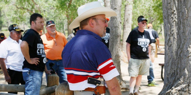 James Rybolt, carrying a .45 Colt pistol, listens at a rally sponsored by Rocky Mountain Gun Owners, marking the one-year anniversary of the Aurora theater shootings, in Aurora, Colorado July 19, 2013. REUTERS/Rick Wilking (UNITED STATES - Tags: CIVIL UNREST DISASTER ANNIVERSARY)