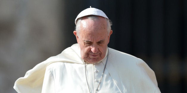 The wind lifts the skullcap of Pope Francis as he leaves after his general audience at St Peter's square on October 30, 2013 at the Vatican. AFP PHOTO / GABRIEL BOUYS (Photo credit should read GABRIEL BOUYS/AFP/Getty Images)