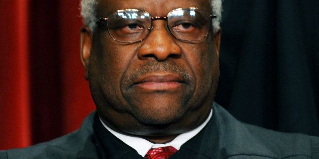 US Supreme Court Associate Justice Clarence Thomas participates in the courts official photo session on October 8, 2010 at the Supreme Court in Washington, DC. AFP PHOTO / TIM SLOAN (Photo credit should read TIM SLOAN/AFP/Getty Images)