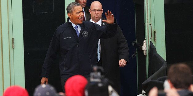 ASBURY PARK, NJ - MAY 28: U.S. President Barack Obama walks on stage before speaking to crowds along a rain soaked boardwalk in Asbury Park on May 28, 2013 in Asbury Park, New Jersey. Seven months after Superstorm Sandy tore apart boardwalks, businesses and towns, President Obama declared that the Jersey Shore is back in an appearance with New Jersey Gov. Chris Christie to points along the Jersey shore. (Photo by Spencer Platt/Getty Images)