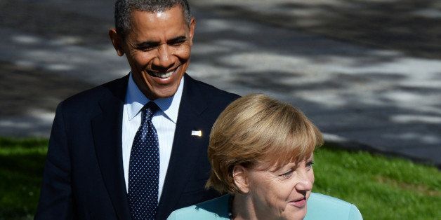 SAINT PETERSBURG - SEPTEMBER 06: U.S. President Barack Obama and German Chancellor Angela Merkel arrive to pose with other leaders for a group photo during the G20 summit on September 6, 2013 in St. Petersburg, Russia. Leaders of the G20 nations made progress on tightening up on multinational company tax avoidance, but remain divided over the Syrian conflict as they enter the final day of the Russian summit. (Photo by Alexey Filippov /Host Photo Agency via Getty Images)
