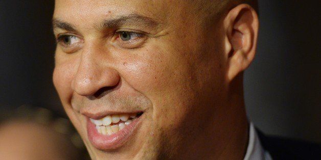 US Senator Cory Booker, D-NJ, smiles while posing for photos following a cermonial swearing-in in the Old Senate Chamber at the US Capitol on October 31, 2013 in Washington, DC. AFP PHOTO/Mandel NGAN (Photo credit should read MANDEL NGAN/AFP/Getty Images)
