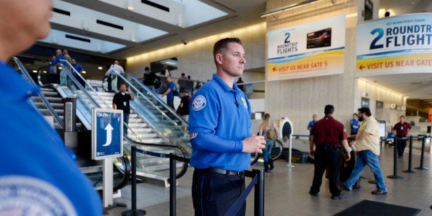 LOS ANGELES, CA - NOVEMBER 1: Transportation Security Administration workers keep a look out as stranded passengers begin to arrive at the departure terminal as normal operations slowly return after a shooting incident at Los Angeles International Airport (LAX) November 1, 2013 in Los Angeles, California. A man identified as Paul Ciancia reportedly pulled out an assault rifle in Terminal 3 of the airport and shot his way through security, killing one Transportation Security Administration (TSA) worker and wounding several others before being shot himself. (Photo by Kevork Djansezian/Getty Images)