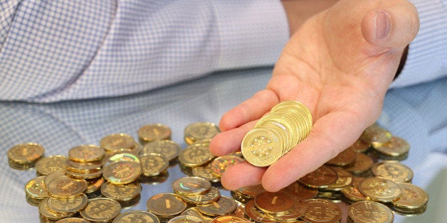 SALT LAKE CITY, UT - APRIL 26: Software engineer Mike Caldwell holds physical Bitcoins he minted in his shop on April 26, 2013 in Sandy, Utah. Bitcoin is an experimental digital currency used over the Internet that is gaining in popularity worldwide. (Photo by George Frey/Getty Images)