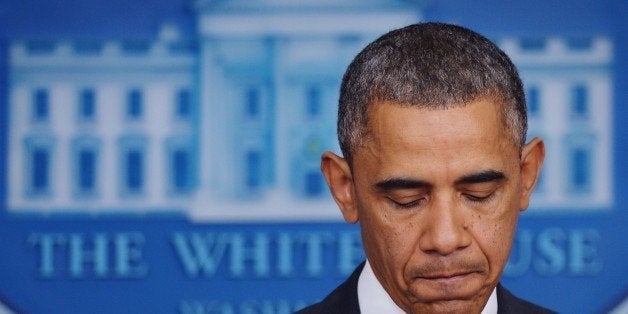 US President Barack Obama pauses as he speaks on the Affordable Care Act in the Brady Press Briefing Room of the White House