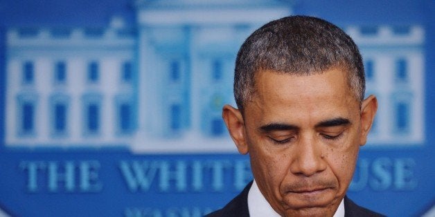 US President Barack Obama pauses as he speaks on the Affordable Care Act in the Brady Press Briefing Room of the White House while reporters do stand-ups on November 14, 2013 in Washington, DC. AFP PHOTO/Mandel NGAN (Photo credit should read MANDEL NGAN/AFP/Getty Images)