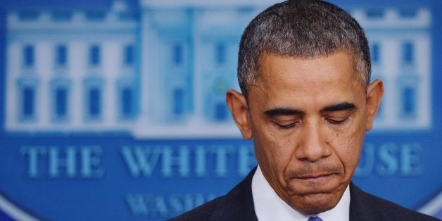 US President Barack Obama pauses as he speaks on the Affordable Care Act in the Brady Press Briefing Room of the White House while reporters do stand-ups on November 14, 2013 in Washington, DC. AFP PHOTO/Mandel NGAN (Photo credit should read MANDEL NGAN/AFP/Getty Images)