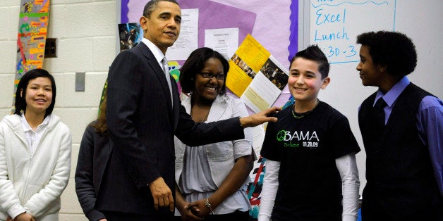 ARLINGTON, VA - MARCH 14: (AFP OUT) U.S. President Barack Obama visits with students in a classroom while at Kenmore Middle School to deliver a speech on reforming education March 14, 2011 in Arlington, Virginia. President Obama called on the Congress 'to fix the No Child Left Behind before the start of the next school year.' (Photo by Leslie E. Kossoff - Pool/Getty Images)