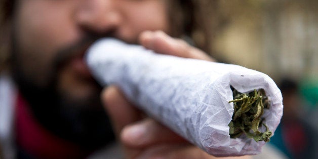 A man holds a giant joint during a march for the legalization of cannabis in Santiago, on May 18, 2013, as part of the 2013 Global Marijuana March which is being held in hundreds of cities worldwide. AFP PHOTO / Martin BERNETTI (Photo credit should read MARTIN BERNETTI/AFP/Getty Images)