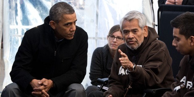 US President Barack Obama(L) listens to people taking part in the Fast for Families on the National Mall in Washington,DC on November 29, 2013. Obama offered support for those fasting for immigration reform. To Obama's right is Eliseo Medina. AFP PHOTO/Nicholas KAMM (Photo credit should read NICHOLAS KAMM/AFP/Getty Images)