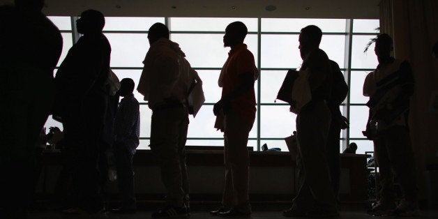 MIAMI, FL - MAY 02: People looking for work stand in line to apply for a job during a job fair at the Miami Dolphins Sun Lif
