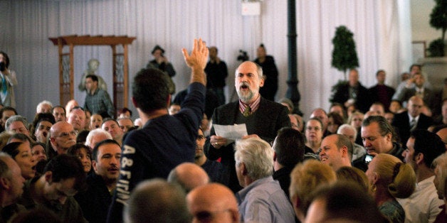NEW YORK, NY - DECEMBER 3: An Occupy Staten Island protester disrupts Republican presidential candidate Newt Gingrich's town