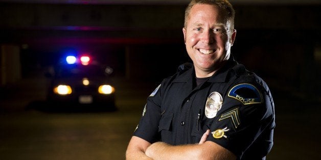 a smiling police officer with...