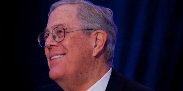 David Koch, executive vice president of Koch Industries Inc., smiles as Mark Carney, governor of the...