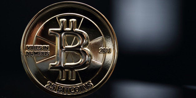 Bloomberg's Best Photos 2013: A twenty-five bitcoin is arranged for a photograph in Tokyo, Japan, on Thursday, April 25, 2013. The digital currency, which carries the unofficial ticker symbol of BTC, was unveiled in 2009 by an unidentified programmer, or group of programmers, under the name of Satoshi Nakamoto. Supply is capped at 21 million Bitcoins and managed by a software algorithm embedded into the digital currencys design, rather than a monetary authority such as a central bank. Photographer: Tomohiro Ohsumi/Bloomberg via Getty Images