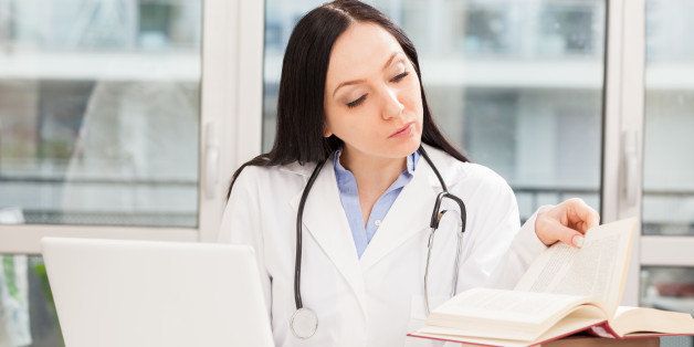 photo of female doctor studying ...