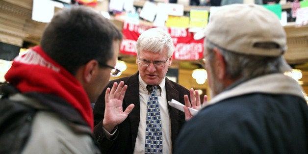 MADISON, WI - MARCH 04: Republican Wisconsin State Senator Glenn Grothman (C) talks with Mark Dziedzic (L) and Jeff Dziedzic inside the Wisconsin State Capitol on March 4, 2011 in Madison,Wisconsin. Some demonstrators have returned to the capitol building hours after they were forced to vacate the building after occupying it for more than two weeks to protest Governor Scott Walker's attempt to push through a bill that would restrict collective bargaining for most government workers in the state. (Photo by Justin Sullivan/Getty Images)