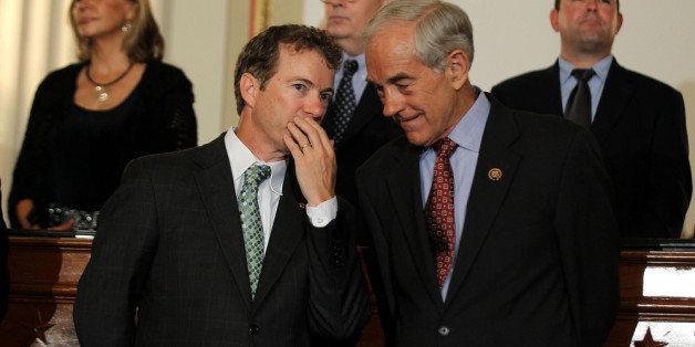WASHINGTON - JUNE 22: U.S. Sen. Rand Paul (R-KY) (L) talks to his father Rep. Ron Paul (R-TX) (R) during a news conference June 22, 2011 on Capitol Hill in Washington, DC. A number of Republican congressional members joined The Cut, Cap, Balance Pledge Coalition at the news conference 'to oppose any debt ceiling increase unless a 'Cut, Cap and Balance' plan is passed.' (Photo by Alex Wong/Getty Images)