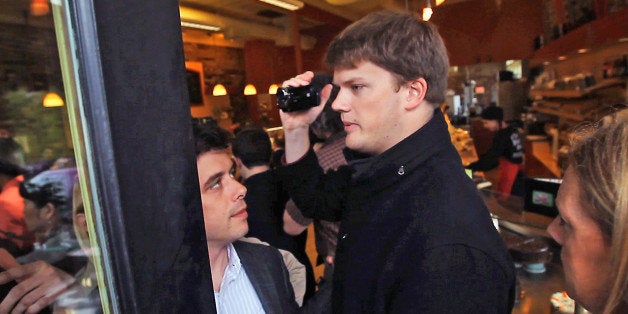 MEDFORD, MA - MAY 9: Tom Daley, holding camera, the Massachusetts Republican Party's tracker, attempted to make his way into Elizabeth Warren's campaign stop at The Danish Pastry House in Medford, but he was quickly halted at the door and asked to leave by Warren's deputy political director, Jess Torres. (Photo by Darren Durlach/The Boston Globe via Getty Images)