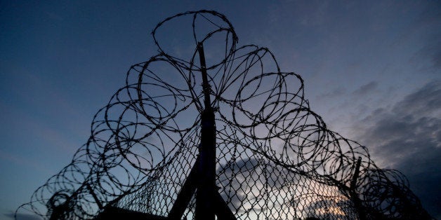 GUANTANAMO BAY, CUBA - JUNE 27: (EDITORS NOTE: Image has been reviewed by the U.S. Military prior to transmission.) Razor wire is seen on the fence around the currently closed Camp X-Ray which was the first detention facility to hold 'enemy combatants' at the U.S. Naval Station on June 27, 2013 in Guantanamo Bay, Cuba.The U.S. Naval Station at Guantanamo Bay, houses the American detention center for 'enemy combatants'. President Barack Obama has recently spoken again about closing the prison which has been used to hold prisoners from the invasion of Afghanistan and the war on terror since early 2002. (Photo by Joe Raedle/Getty Images)