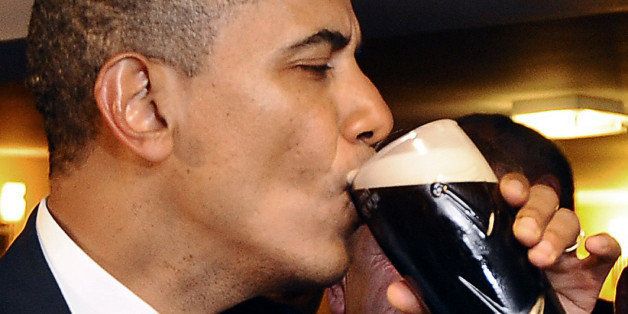 CROPPED VERSIONUS President Barack Obama sips a Guinness at a pub as they visit Moneygall village in rural County Offaly, Ireland, where his great-great-great grandfather Falmouth Kearney hailed from, on May 23, 2011. Obama landed in Ireland on May 23, 2011 for a visit celebrating his ancestral roots, kicking off a four-nation European tour. AFP PHOTO/ JEWEL SAMAD (Photo credit should read JEWEL SAMAD/AFP/Getty Images)