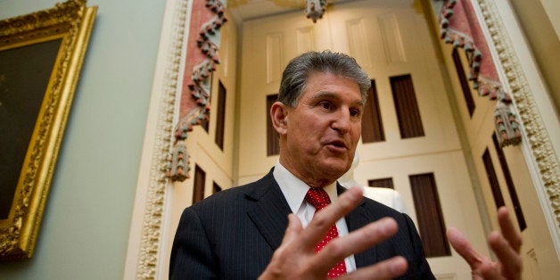 UNITED STATES - Jan 14: Sen. Joe Manchin, D-WVA., talks with reporters on the way to the Senate policy luncheons in the U.S.