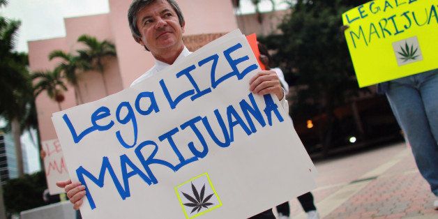 FORT LAUDERDALE, FL - OCTOBER 12: Florida Attorney General candidate Jim Lewis, who is running on a platform of legalizing marijuana, holds a sign during a campaign rally on October 12, 2010 in Fort Lauderdale, Florida. Lewis believes that legalizing the drug will save the state hundreds of millions of dollars that can be redirected for spending on education, environment, and other necessary items. (Photo by Joe Raedle/Getty Images)