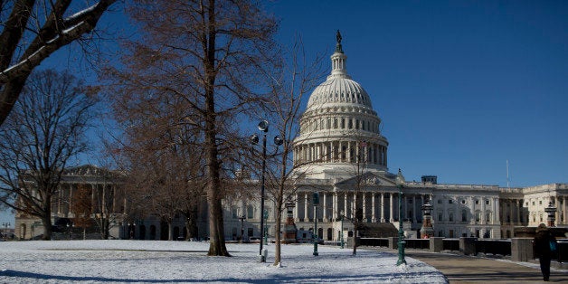 A pedestrian walks near the U.S. Capitol in Washington, D.C., U.S., on Friday, Jan. 3, 2014. A storm along the U.S. East Coast brought snow and wind chills to the region, disrupting travel amid highway closures and thousands of flight cancellations. Photographer: Andrew Harrer/Bloomberg via Getty Images