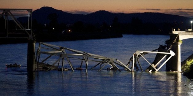 MT. VERNON, WASHINGTON - MAY 23: A boat cruises past the scene of a bridge collapse on Interstate 5 on May 23, 2013 near Mt. Vernon, Washington. 1-5 connects Seattle, Washington to Vancouver, B.C., Canada. No deaths have been reported, and three people were taken to hospitals with injuries. (Stephen Brashear/Getty Images)