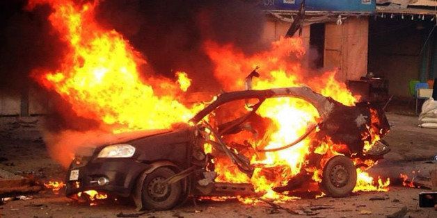 A blaze engulfs a car at the scene of an explosion in the Shiite Muslim Al-Amin district of Baghdad on December 8, 2013. A series of bombings, which hit five different areas in and around the Iraqi capital on December 8, killed at least 16 people, security and medical officials said, while another car bomb near a cafe in Buhruz, a Sunni-majority town in the religiously and ethnically mixed Diyala province northeast of Baghdad, killed more than 10 people on December 9 in the latest in a series of attacks on crowded public places this year. AFP PHOTO/STR (Photo credit should read STR/AFP/Getty Images)