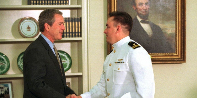 (L-R) President George W. Bush shaking hands w. Navy Lt. Shane Osborn during a meeting in the Oval Office of the White House. Osborn piloted the Navy surveillance plane that was held on China's Hainan island. (Photo by Mai/Mai/Time Life Pictures/Getty Images)