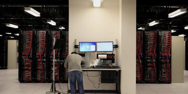 A server build technician stands at a work bench while monitoring a clients data and performing maintenance inside pod two of International Business Machines Corp.'s (IBM) Softlayer data center in Dallas, Texas, U.S., on Thursday, Jan. 16, 2014. IBM is scheduled to release earnings figures on Jan. 21. Photographer: Ben Torres/Bloomberg via Getty Images