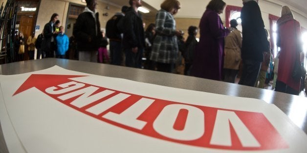 People queue to cast their ballots at a polling station in Washington,DC on November 6, 2012. Americans head to the polls after a burst of last-minute campaigning by President Barack Obama and Mitt Romney in a nail-biting contest unlikely to heal a deeply polarized nation. After a long, expensive and fiercely negative campaign, voters will decide whether to re-elect Obama despite the plodding economy or hand the reins to Romney, who has vowed a return to prosperity through smaller government. AFP PHOTO/Nicholas KAMM (Photo credit should read NICHOLAS KAMM/AFP/Getty Images)