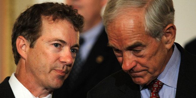 WASHINGTON - JUNE 22: U.S. Sen. Rand Paul (R-KY) (L) talks to his father Rep. Ron Paul (R-TX) (R) during a news conference June 22, 2011 on Capitol Hill in Washington, DC. A number of Republican congressional members joined The Cut, Cap, Balance Pledge Coalition at the news conference 'to oppose any debt ceiling increase unless a 'Cut, Cap and Balance' plan is passed.' (Photo by Alex Wong/Getty Images)