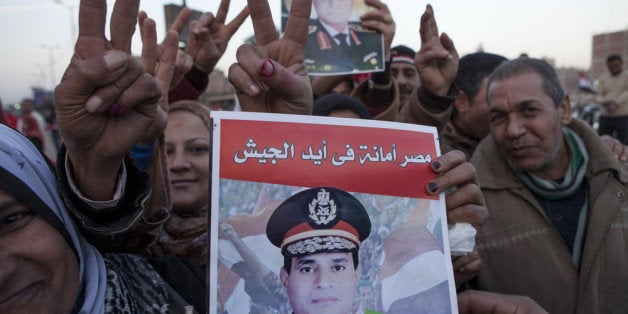 CAIRO, EGYPT - JANUARY 15: Supporters of Egyptian Defense Minister Abdel Fattah al-Sisi celebrate at the end of the second day of voting in Egypt's constitutional referendum in the Shubra district on January 15, 2014 in Cairo, Egypt. Egyptians went to the polls for a second day on Wednesday, after the first day of voting on Tuesday was marred by clashes between protesters and security forces, and one explosion at a courthouse, in the Egyptian capital Cairo. Egyptians voted in the referendum to decide on the third constitution for Egypt since the overthrow of former President Hosni Mubarak in February 2011. (Photo by Ed Giles/Getty Images).