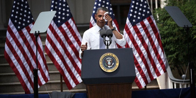 WASHINGTON, DC - JUNE 25: U.S. President Barack Obama wipes sweat off his face as he unveils his plan on climate change June 25, 2013 at Georgetown University in Washington, DC. President Obama laid out his plan to diminish carbon pollution and prepare the country for the impacts of climate change. (Photo by Alex Wong/Getty Images)