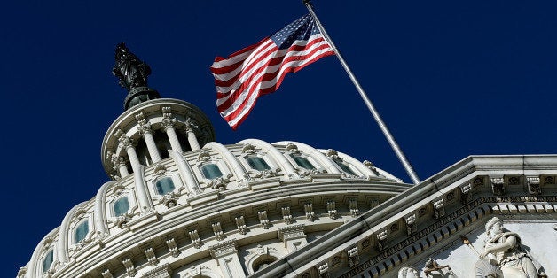 WASHINGTON, DC - SEPTEMBER 29: An American flag waves outside the United States Capitol building as Congress remains gridloc
