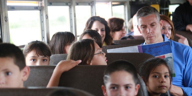 COLUMBUS, NM - SEPTEMBER 10: Secretary of Education Arne Duncan rides the bus with Columbus Elementary students to the Mexico-US border in Columbus, New Mexico in September 10, 2013. Hundreds of the school's children reside in Palomas, Mexico and cross the border everyday to attend school in New Mexico. (Photo by Gabe Silverman/The Washington Post via Getty Images)