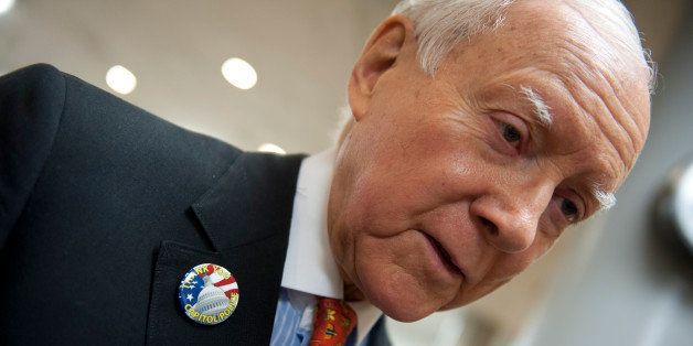 UNITED STATES - Oct 8: Sen. Orrin Hatch, R-UT., talks to reporters as he makes his way to the Senate policy luncheons through the senate subway in the U.S. Capitol on October 8, 2013. Hatch was sporting a pin think the Capitol Police for staying on the job and protecting them during the shootings on Capitol Hill and through the government shutdown. (Photo By Douglas Graham/CQ Roll Call)