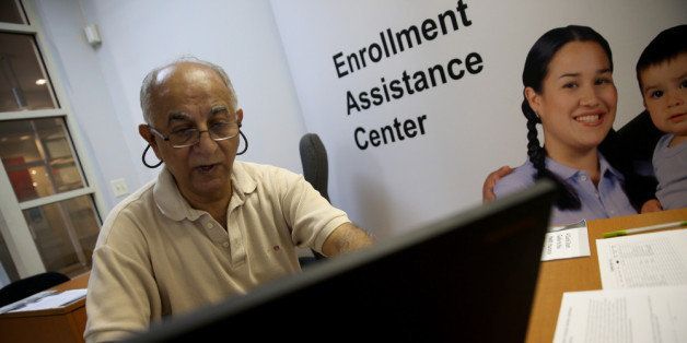 MIAMI, FL - DECEMBER 23: Narendra Parmar finishes the process of picking and signing up for health insurance through the Affordable Care act at a Miami Enrollment Assistance Center on December 23, 2013 in Miami, Florida. Today is the deadline for people to enroll in a plan that would start January 1st. (Photo by Joe Raedle/Getty Images)
